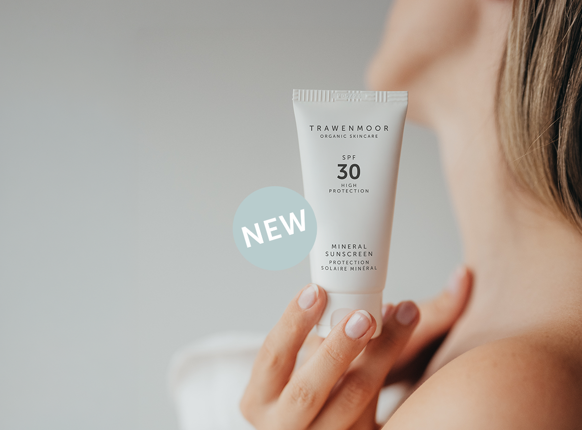 woman with sunscreen in her hand