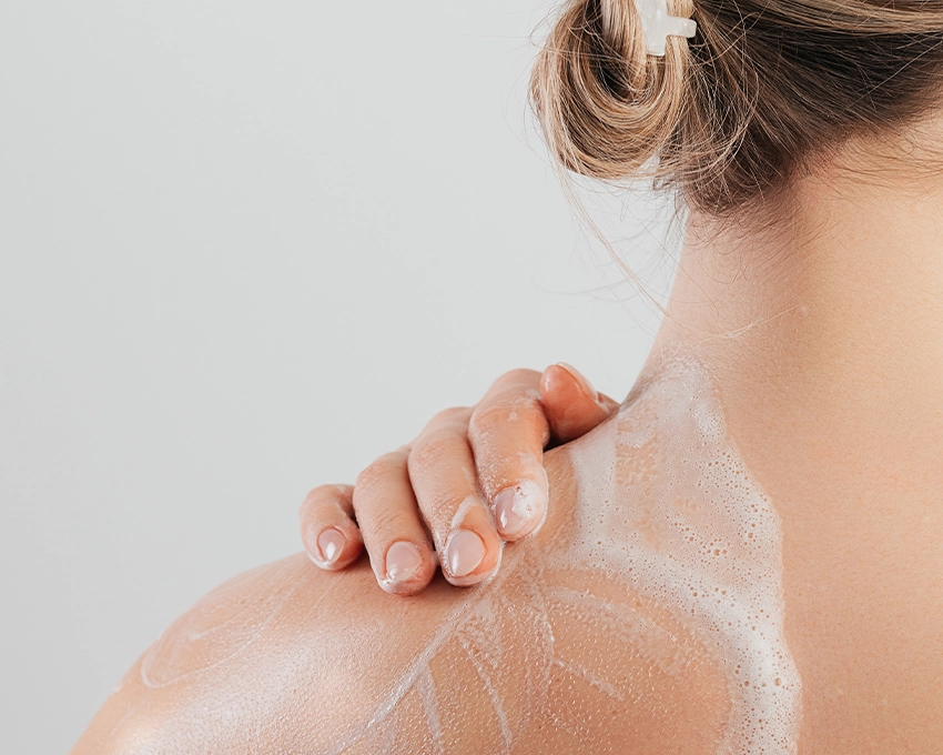 Frau trägt Trawenmoor Bodywash auf ihren Nacken auf